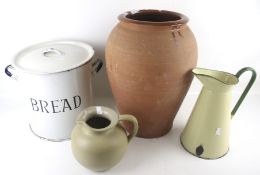A large terracotta storage jar, an enamel bread bin and two jugs. Max.