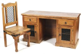 A hardwood pedestal desk and chair. The chair with metalwork details.
