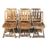 A set of six rustic wooden chairs.