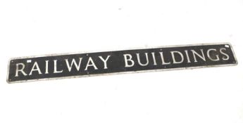 An embossed metal house sign 'Railway Buildings'.