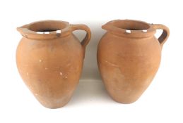 A pair of large terracotta jugs.