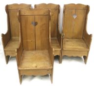 A set of four pine settle style chairs with heart details.