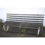 A traditional style metal framed and wood garden bench.