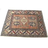 A Persian style woollen blend rug.