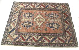 A Persian style woollen blend rug.