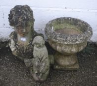 A collection of three stone garden ornaments.