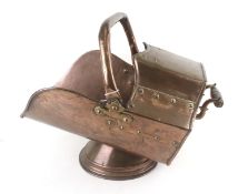 An Arts and Crafts style copper coal scuttle.