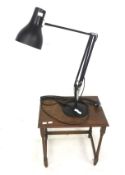 An anglepoise desk light and a small side table. The anglepoise black in colour, Max.