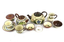 Nine Devon Torquay motto wares and a Susie Cooper pin dish. Including teapots, a jug, bowls, etc.