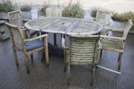 A teak extending garden table,