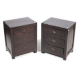 A pair of hardwood bedside chests of three drawers.