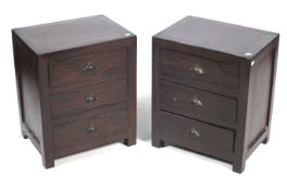 A pair of hardwood bedside chests of three drawers.