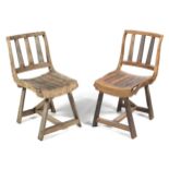 A pair of rustic hardwood chairs.