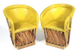 A pair of wood and yellow leather tub chairs.