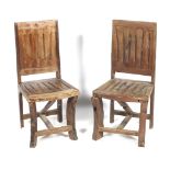 A pair of hardwood dining chairs.