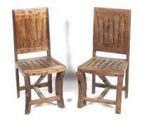 A pair of hardwood dining chairs.
