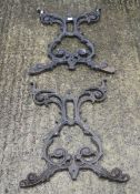 A cast metal garden table base in two sections.