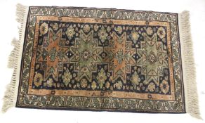 A Persian style silk blend rug. With geometric boarder and designs.