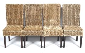 A set of four rattan dining chairs.