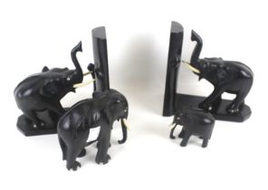 A pair of ebony elephant bookends and two elephant figures. Max.