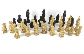 A contemporary oriental chess set. The resin pieces moulded as temple dogs, deities, etc. Max.