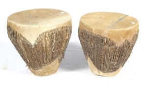 A pair of African tribal animal hide drums.