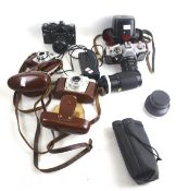 An assortment of film cameras. Including a Kodak Colour Snap 35, Praktica Super TL2, etc.