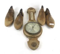 Two pairs of vintage wooden shoe lasts and a barometer.