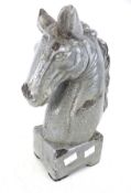 A large ceramic horse head ornament. Blue grey crackle glaze.