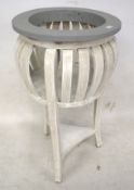 A contemporary white and grey painted plant stand.