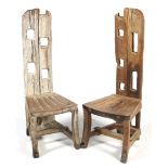 A pair of drift wood style high back chairs.