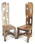 A pair of drift wood style high back chairs.