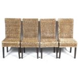A set of four rattan dining chairs.