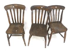 A set of three vintage stained oak kitchen chairs.