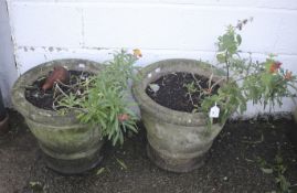 A pair of stone garden urns.