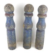 Three large vintage wooden skittles painted blue.