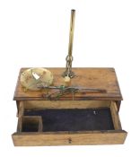 A vintage miniature set of scales. Mounted on a wooden box with a drawer.