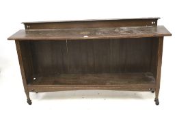 A vintage low bookcase on castors. With one adjustable shelf.