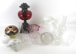 An assortment of Victorian and later oil lamp components.