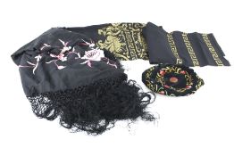 A Spanish shawl, a black shawl and an embroidered hat.