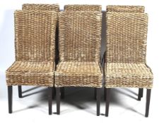 A set of six rattan dining chairs.