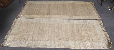 A pair of coarse woven rugs.