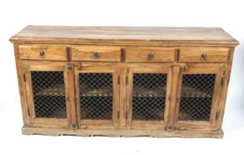 A hardwood sideboard with metalwork doors.