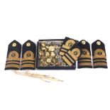 A collection of assorted Gieves military buttons, naval epaulettes and a whistle.