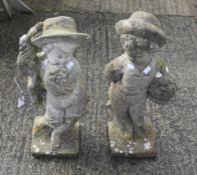 A pair of stone garden boy figures.