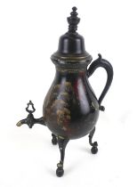 A vintage Dutch kettle with painted decoration. On tripod supports.