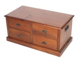 A contemporary hardwood coffee table with drawers.