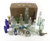 A collection of vintage glass bottles in a wooden case.