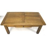 A contemporary oak coffee table. With a single drawer beneath.