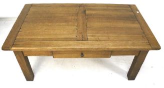 A contemporary oak coffee table. With a single drawer beneath.